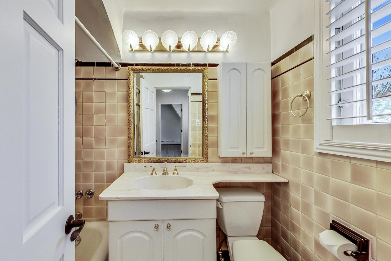 280 Nuttall Road Riverside, IL 60546 - Photo 18 of 52 a bathroom with a sink a mirror a toilet and a shower