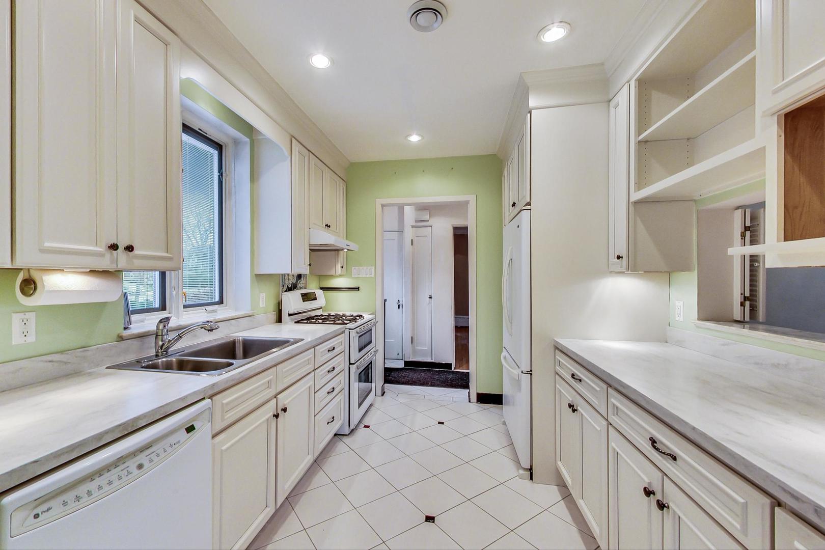 280 Nuttall Road Riverside, IL 60546 - Photo 7 of 52 a kitchen with white cabinets and sink