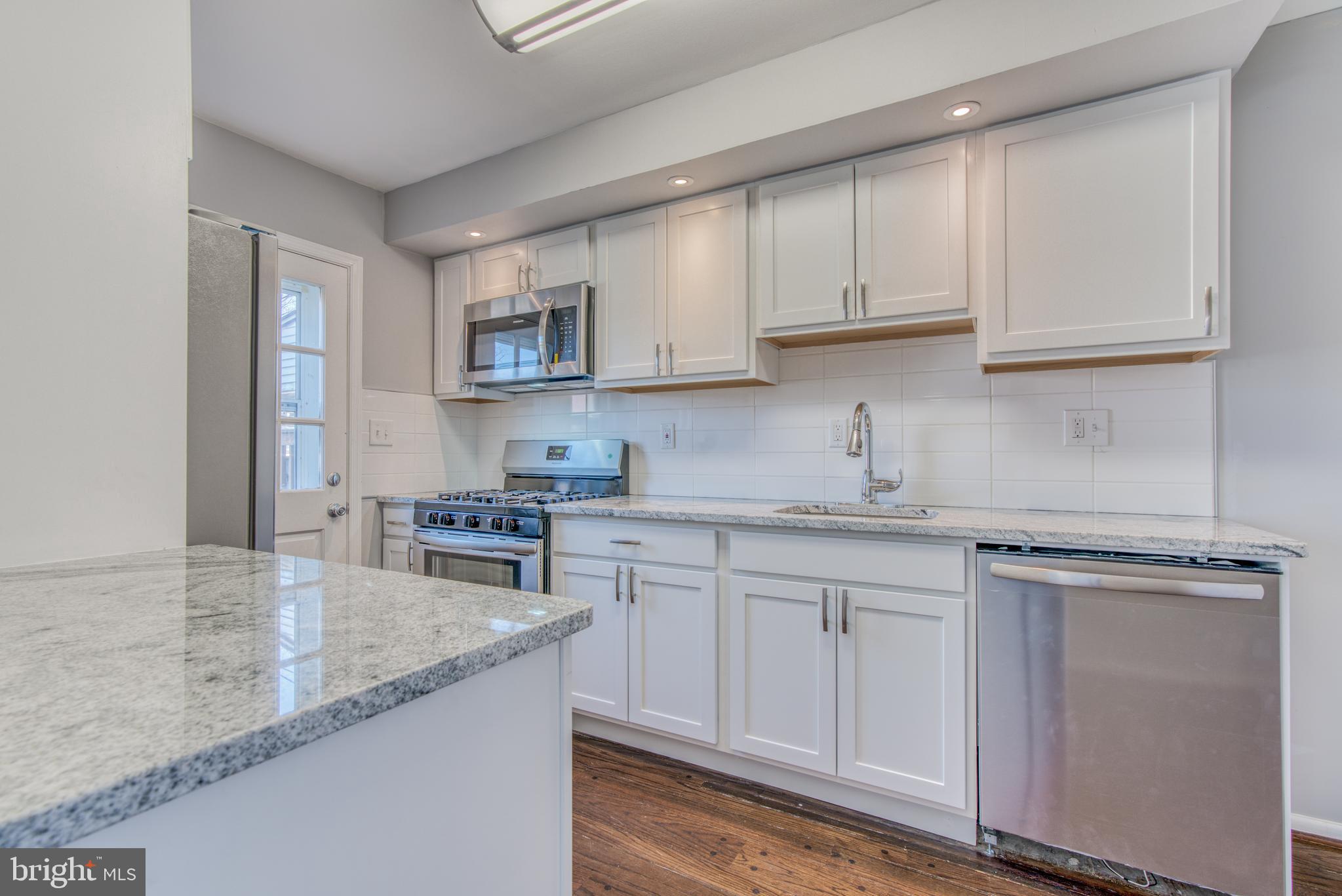 531 Grovethorn Road Baltimore, MD 21220 - Photo 1 of 56 a kitchen with granite countertop a sink stove and cabinets