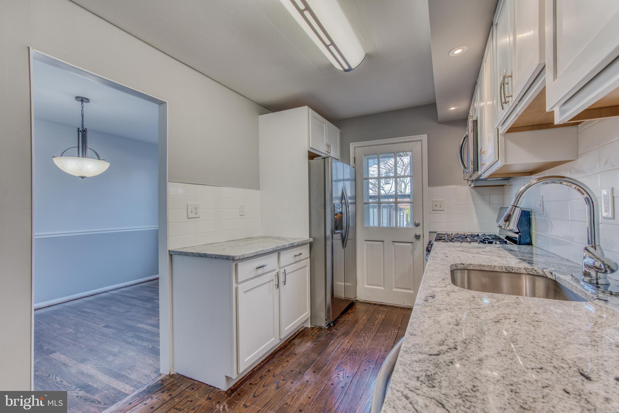 531 Grovethorn Road Baltimore, MD 21220 - Photo 15 of 56 a kitchen with granite countertop a sink stove and refrigerator