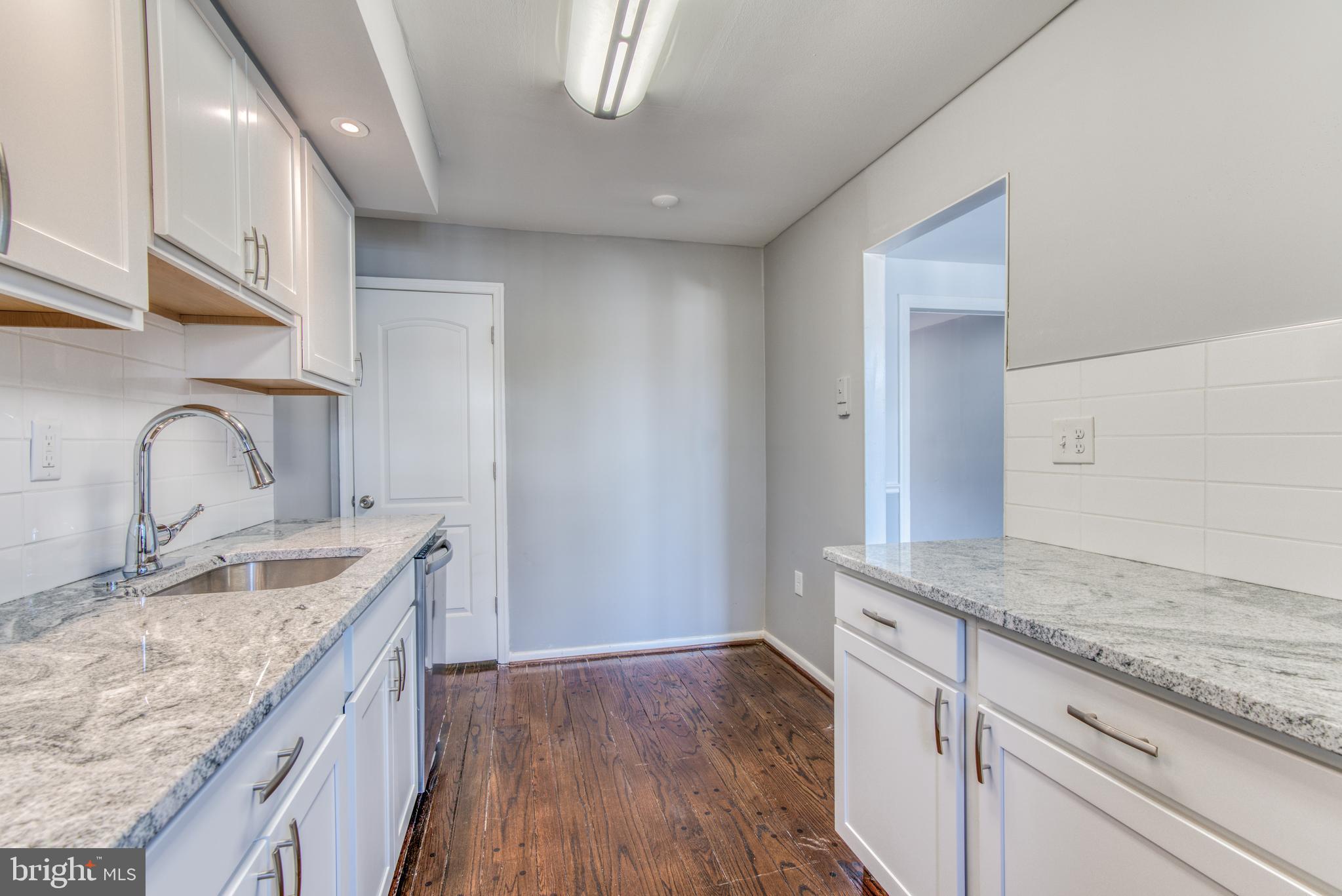 531 Grovethorn Road Baltimore, MD 21220 - Photo 17 of 56 a kitchen with granite countertop white cabinets and sink