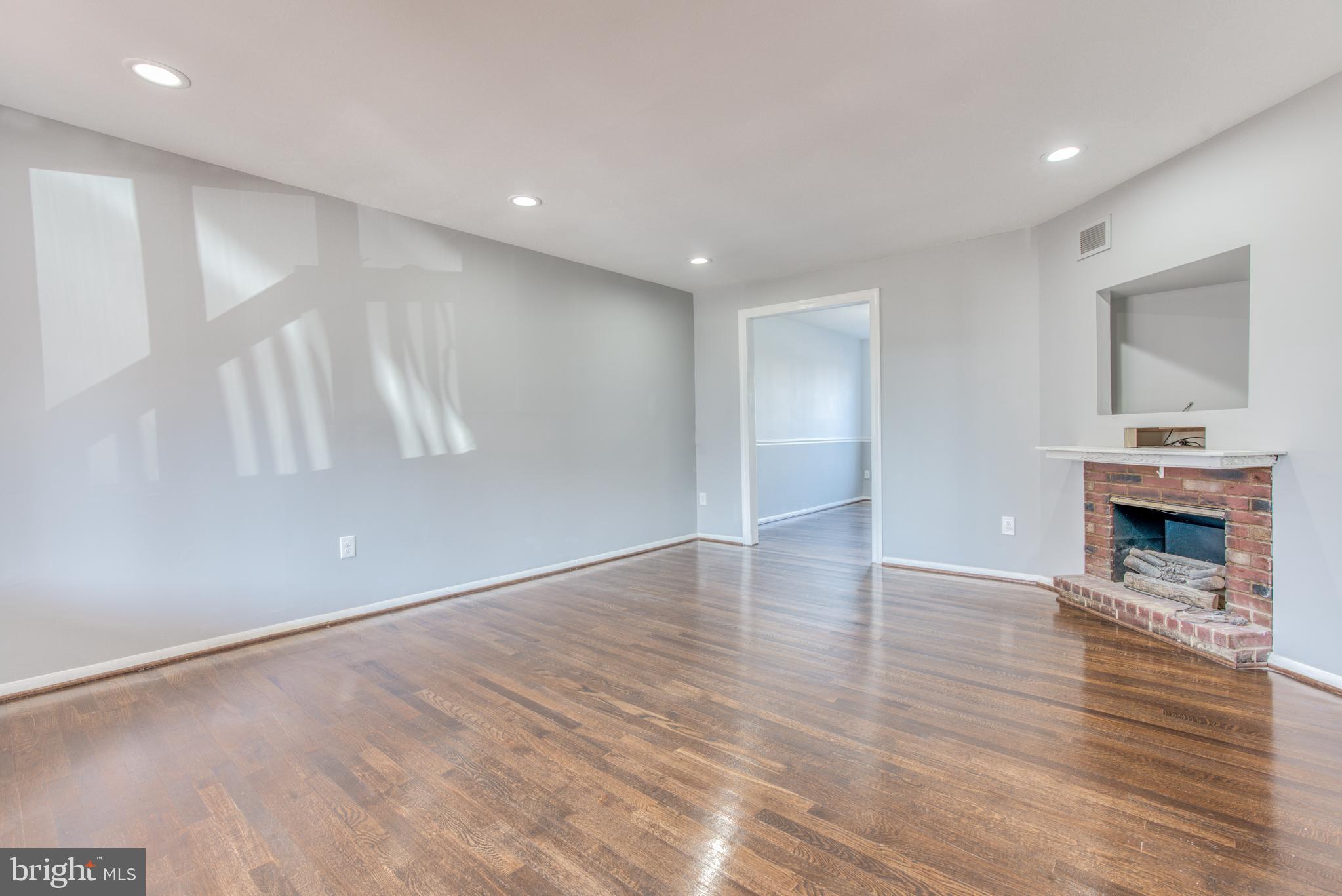 531 Grovethorn Road Baltimore, MD 21220 - Photo 3 of 56 a view of an empty room with wooden floor and a fireplace