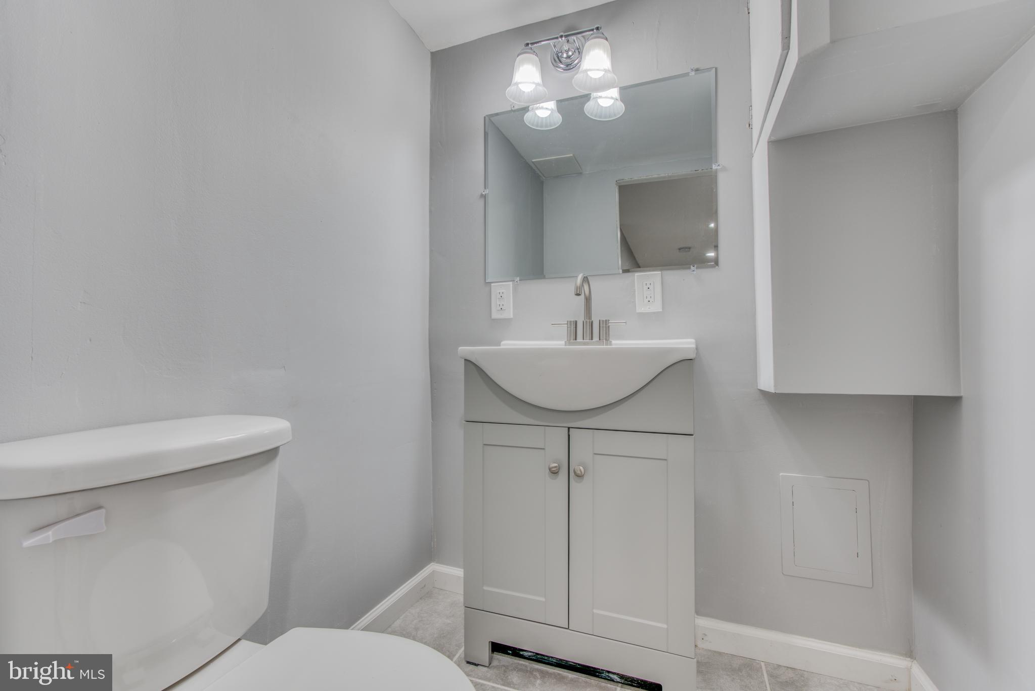 531 Grovethorn Road Baltimore, MD 21220 - Photo 28 of 56 a bathroom with a sink a toilet and mirror