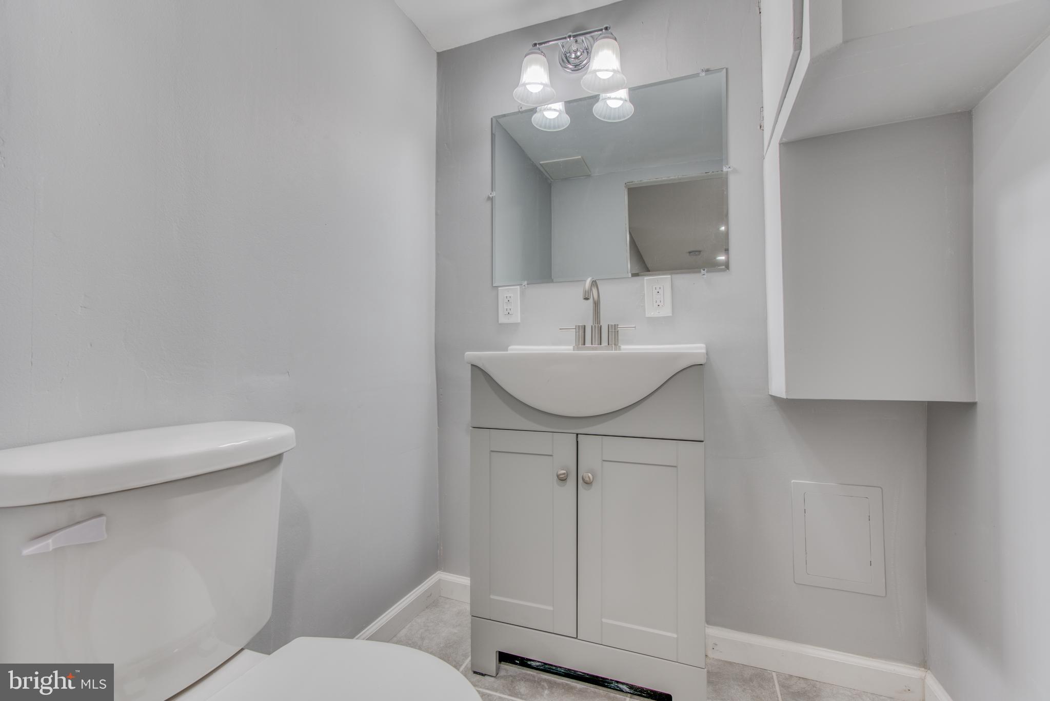 531 Grovethorn Road Baltimore, MD 21220 - Photo 29 of 56 a bathroom with a sink a toilet and mirror