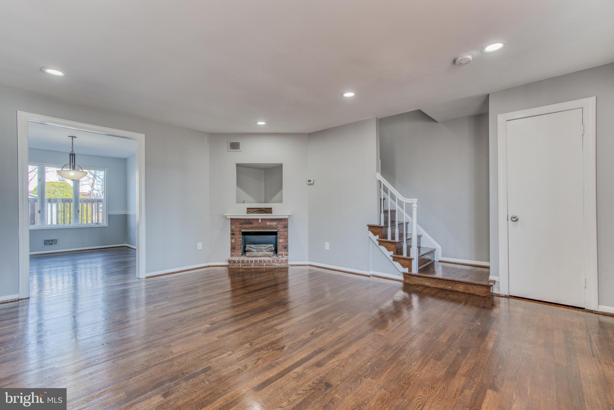 531 Grovethorn Road Baltimore, MD 21220 - Photo 4 of 56 an empty room with wooden floor staircase and windows