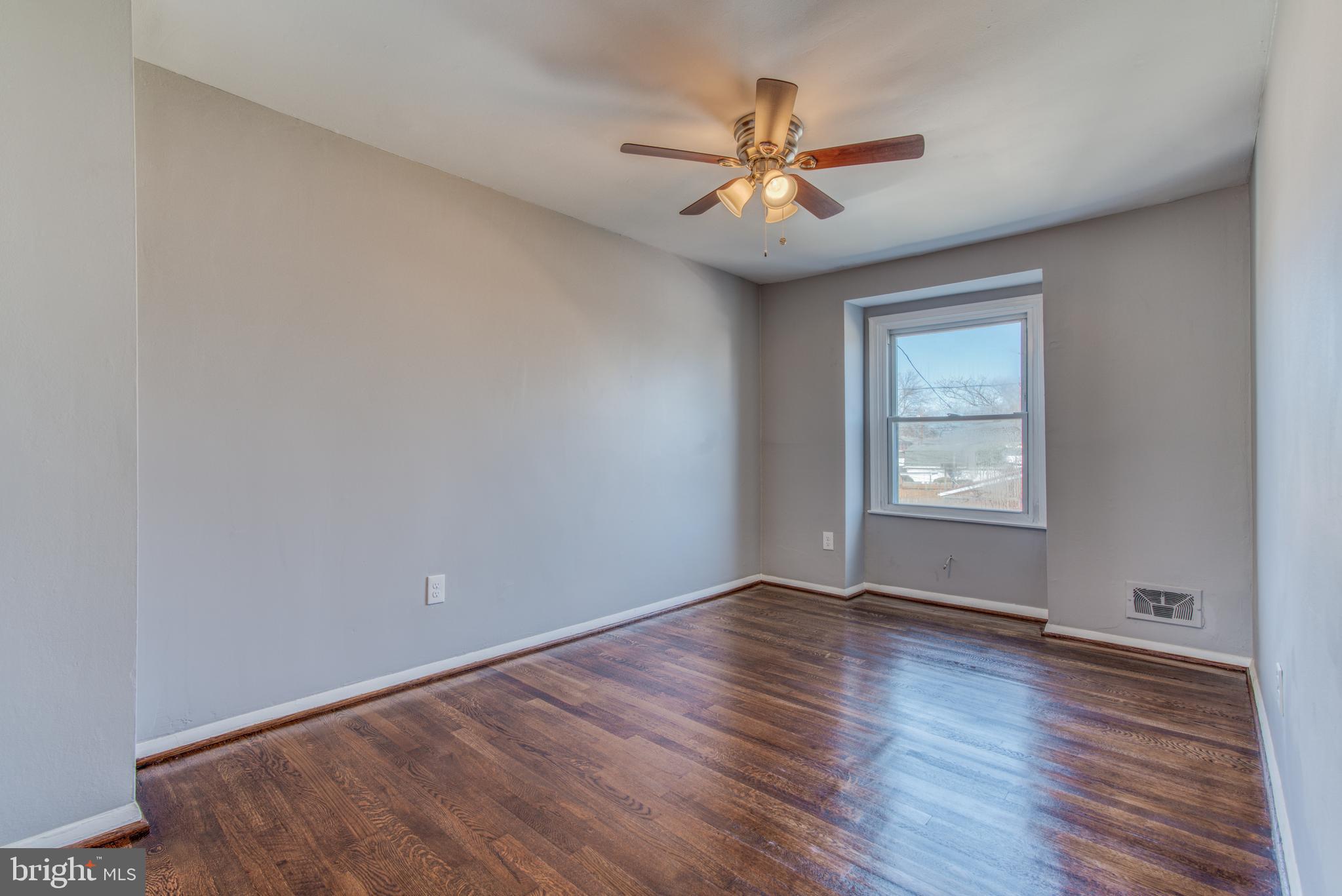 531 Grovethorn Road Baltimore, MD 21220 - Photo 37 of 56 a view of an empty room with wooden floor and a window