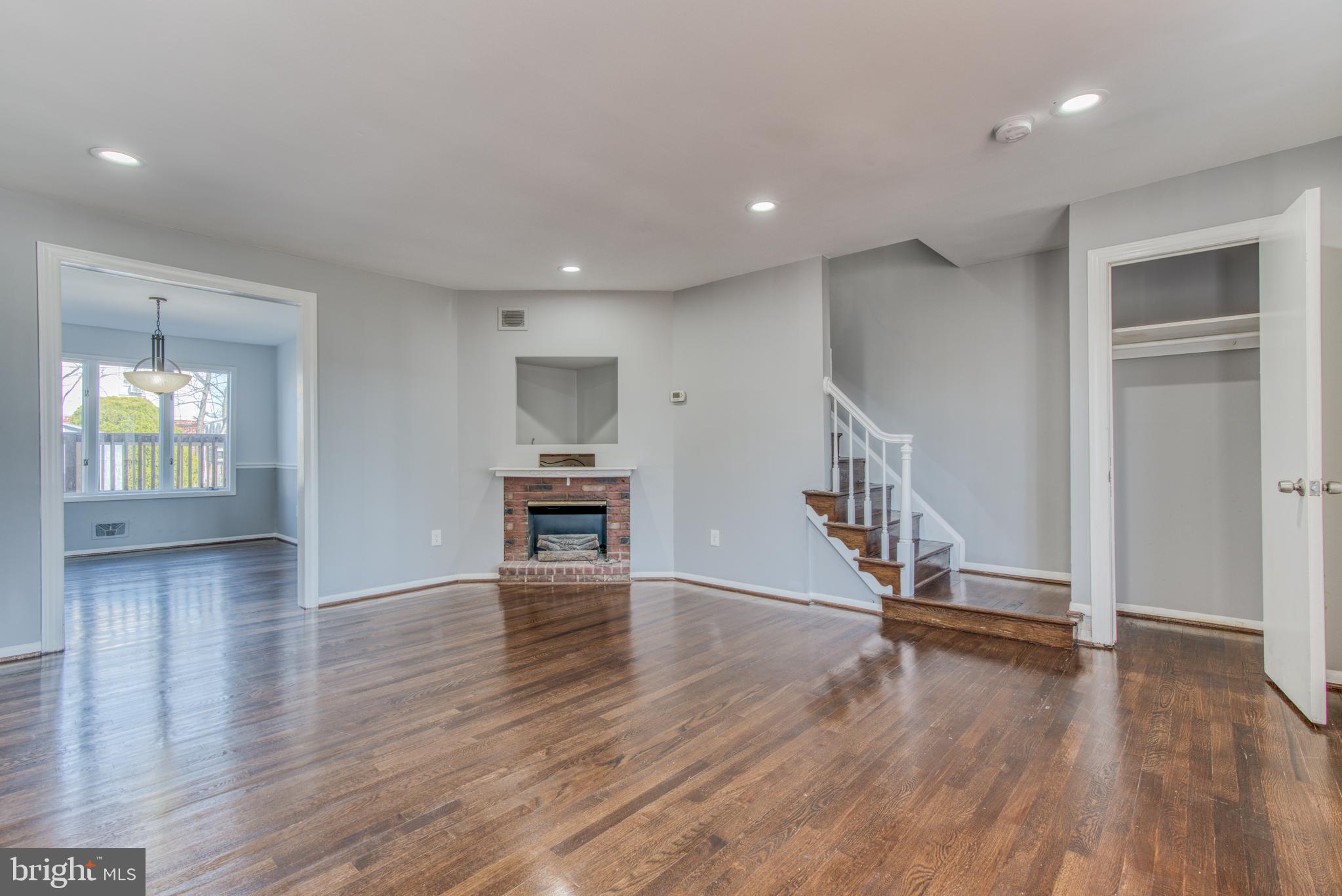 531 Grovethorn Road Baltimore, MD 21220 - Photo 5 of 56 an empty room with wooden floor staircase and windows