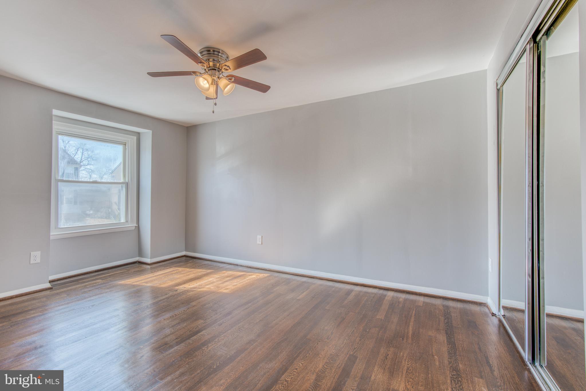 531 Grovethorn Road Baltimore, MD 21220 - Photo 41 of 56 an empty room with wooden floor fan and windows