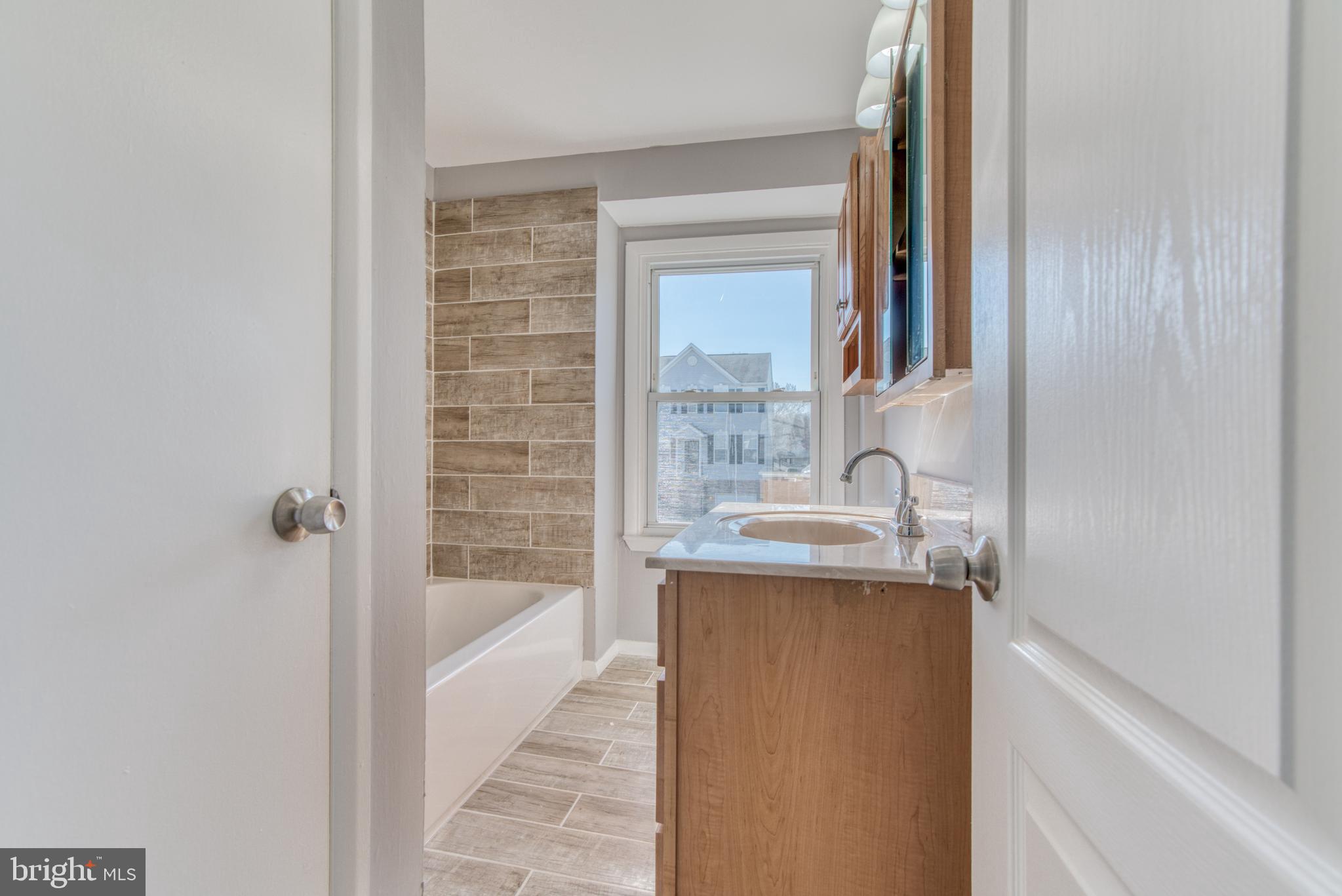 531 Grovethorn Road Baltimore, MD 21220 - Photo 43 of 56 a bathroom with a granite countertop sink a toilet and shower