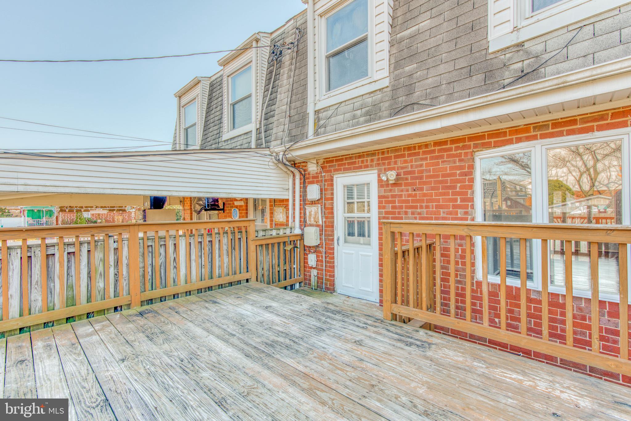 531 Grovethorn Road Baltimore, MD 21220 - Photo 50 of 56 a view of a brick house with a wooden deck