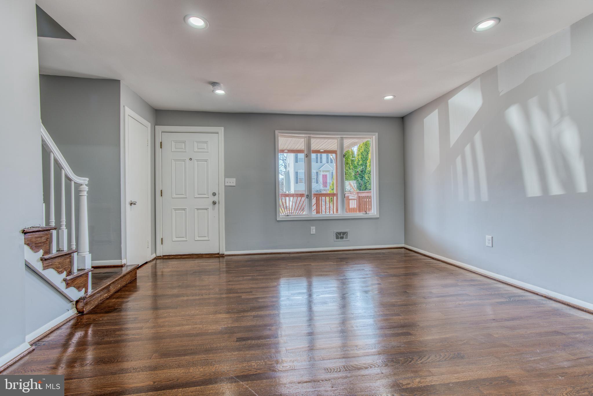 531 Grovethorn Road Baltimore, MD 21220 - Photo 8 of 56 a view of an empty room with wooden floor and a window