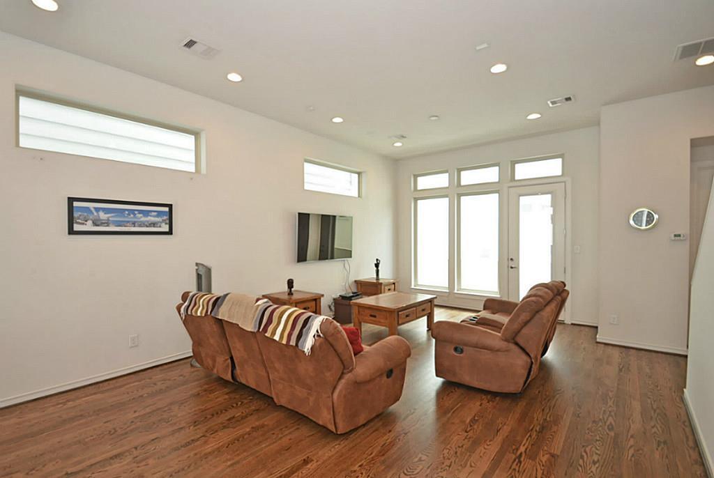 2713 Clay Street Houston, TX 77003 - Photo 11 of 24 Plenty of windows allow natural light to fill the large and spacious Living Room that opens up to the balcony on this floor.