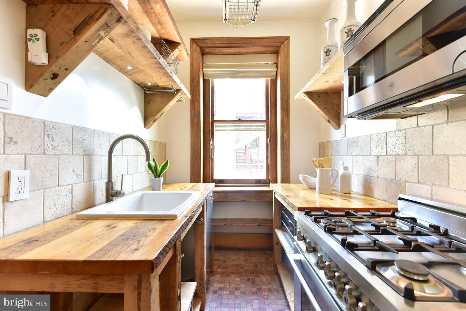 1725 17th Street Northwest, Unit 207 Washington, DC 20009 - Photo 1 of 28 a kitchen with a stove and a sink