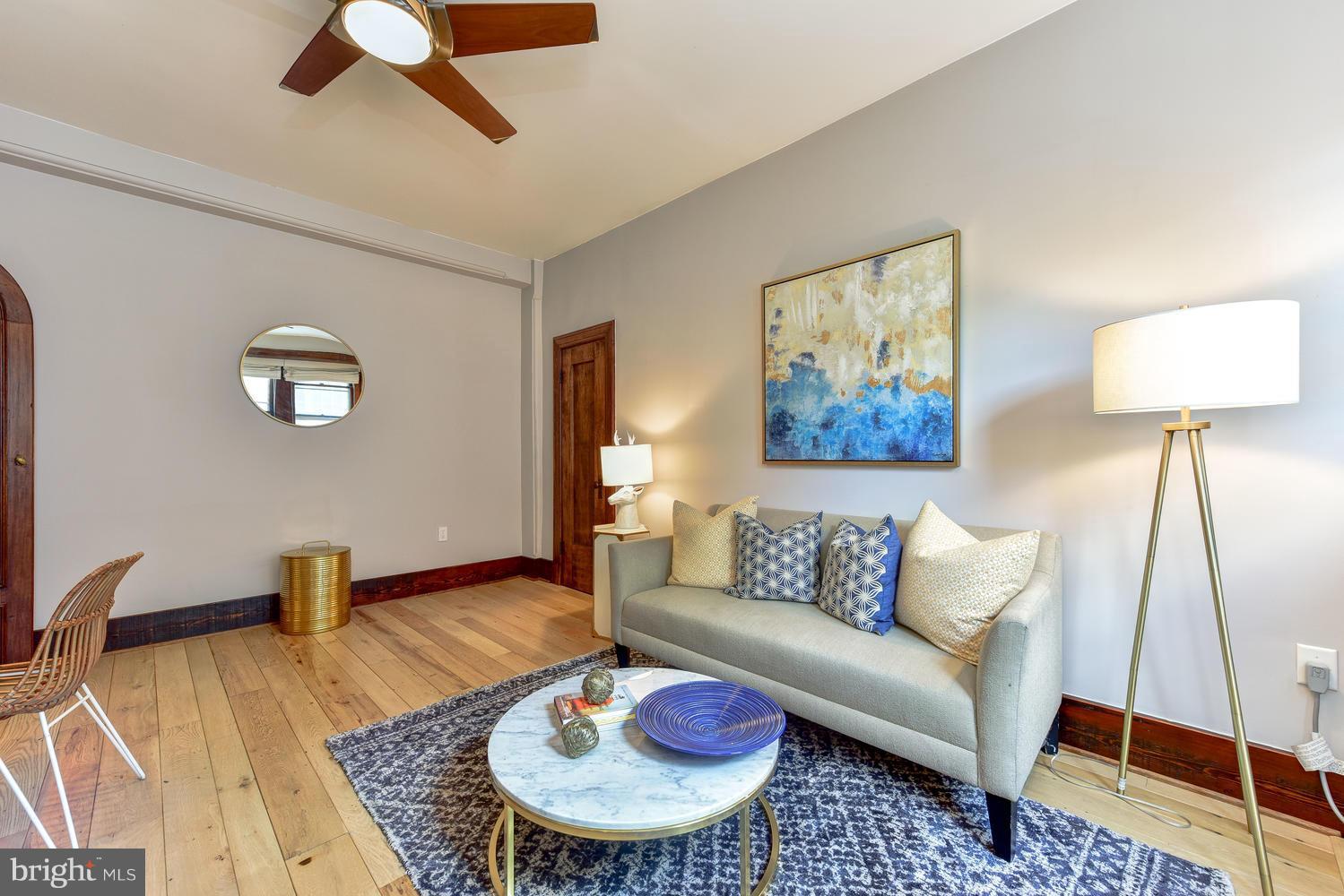 1725 17th Street Northwest, Unit 207 Washington, DC 20009 - Photo 13 of 28 a living room with furniture and a rug