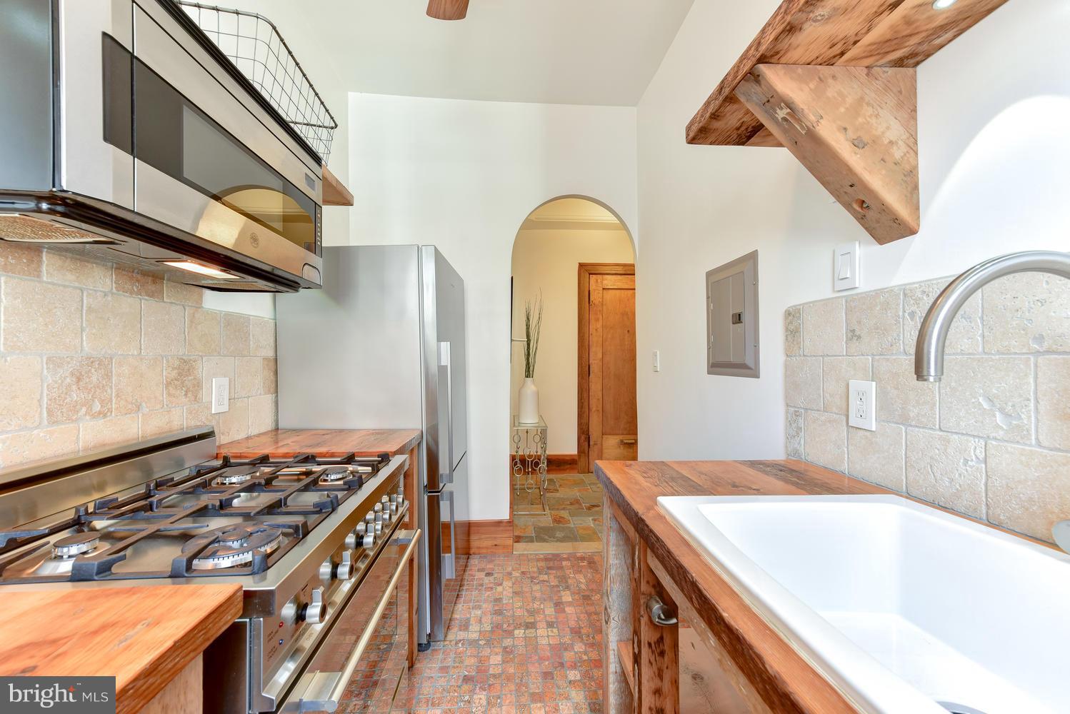1725 17th Street Northwest, Unit 207 Washington, DC 20009 - Photo 3 of 28 a kitchen with a stove a sink and a refrigerator