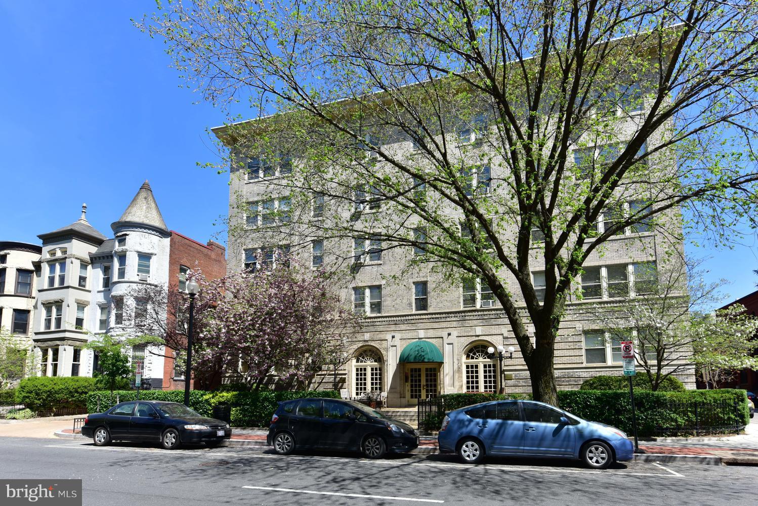 1725 17th Street Northwest, Unit 207 Washington, DC 20009 - Photo 22 of 28 a front view of a building with lot of cars and trees