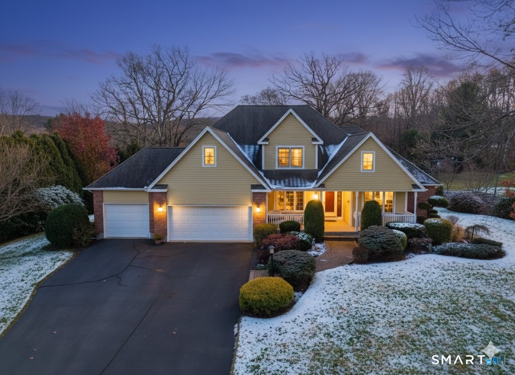 a front view of a house with garden and parking