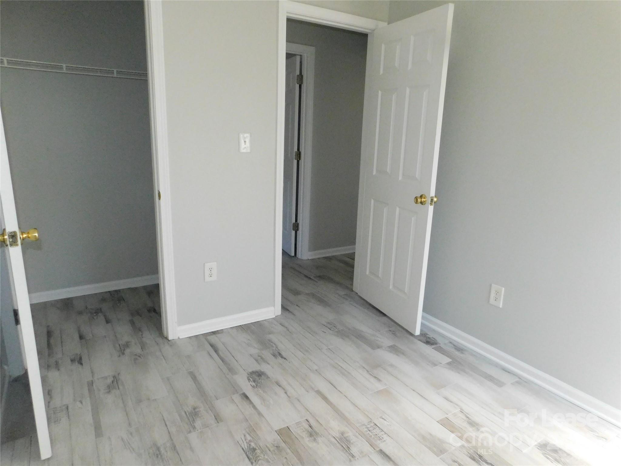 1119 Hannah Rae Court Charlotte, NC 28214 - Photo 12 of 19 an empty room with wooden floor and entrance