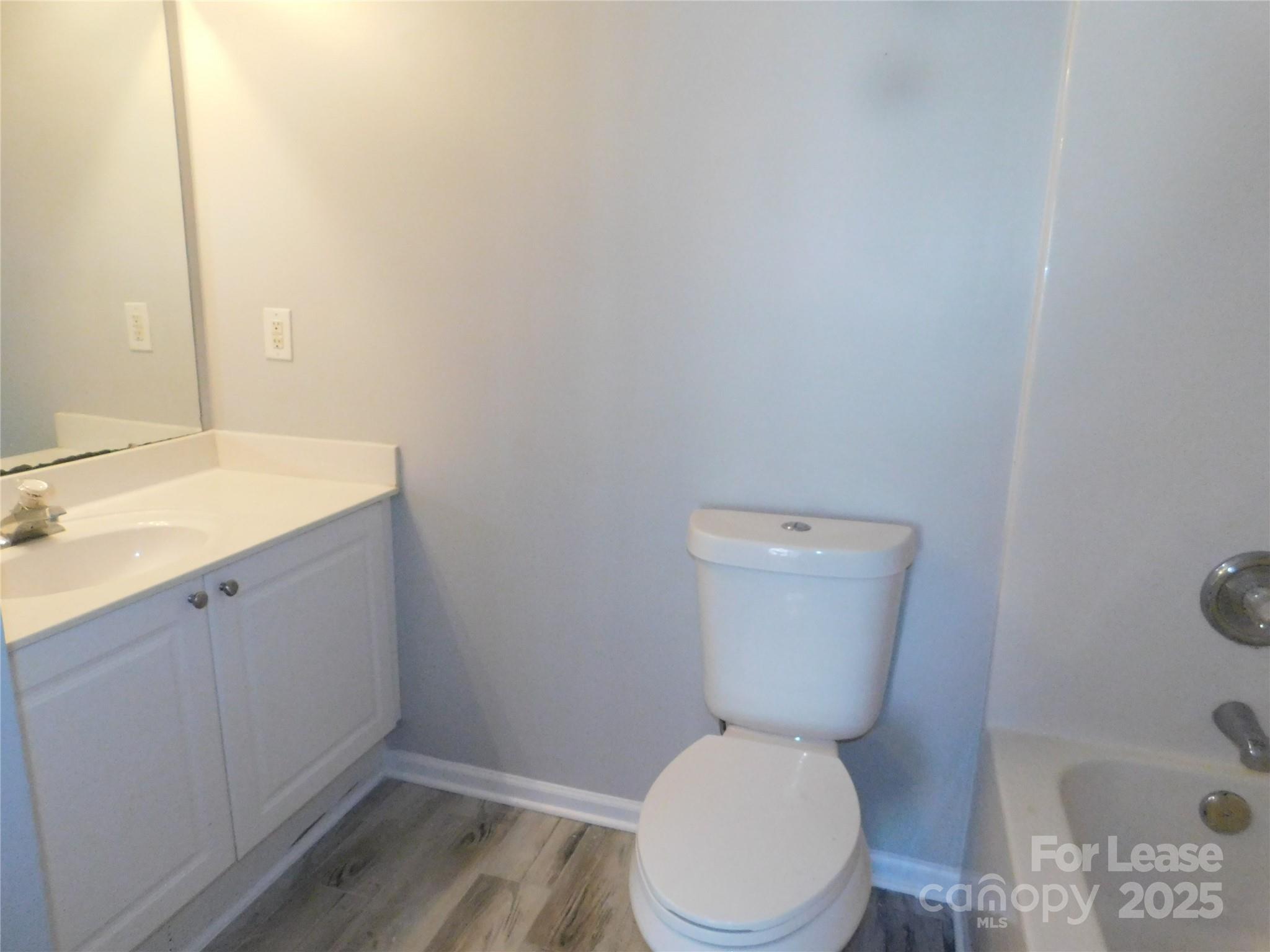 1119 Hannah Rae Court Charlotte, NC 28214 - Photo 19 of 19 a white toilet sitting next to a bathroom sink