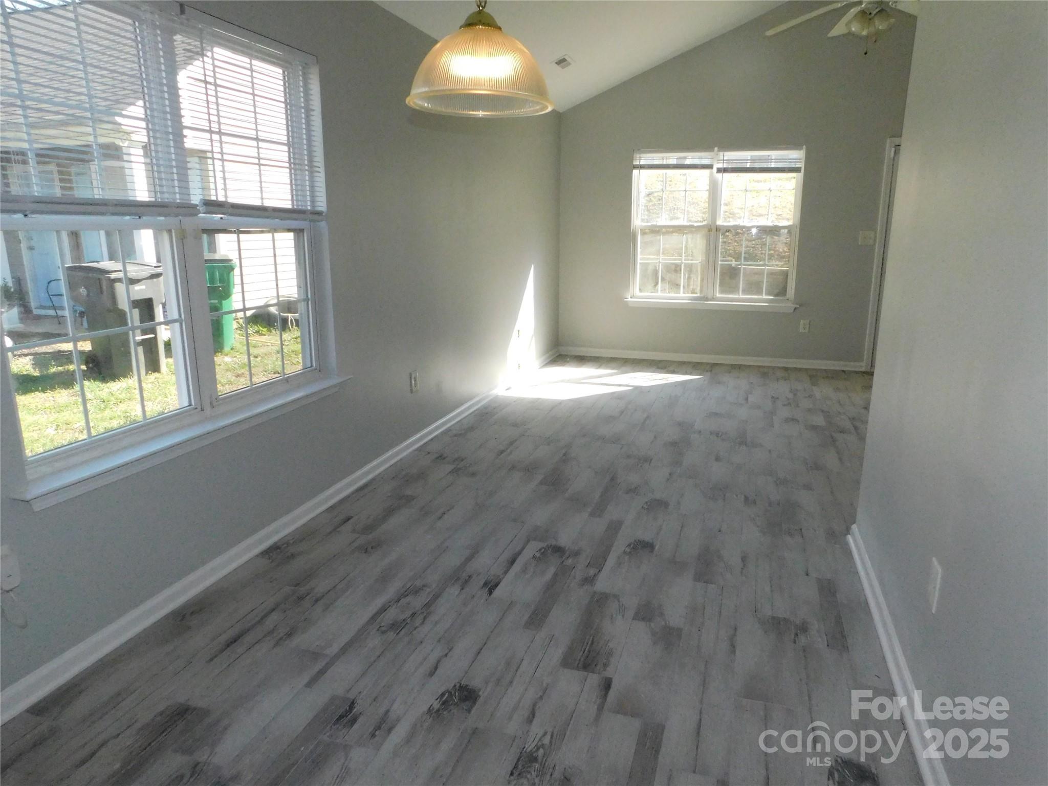 1119 Hannah Rae Court Charlotte, NC 28214 - Photo 5 of 19 an empty room with wooden floor and windows