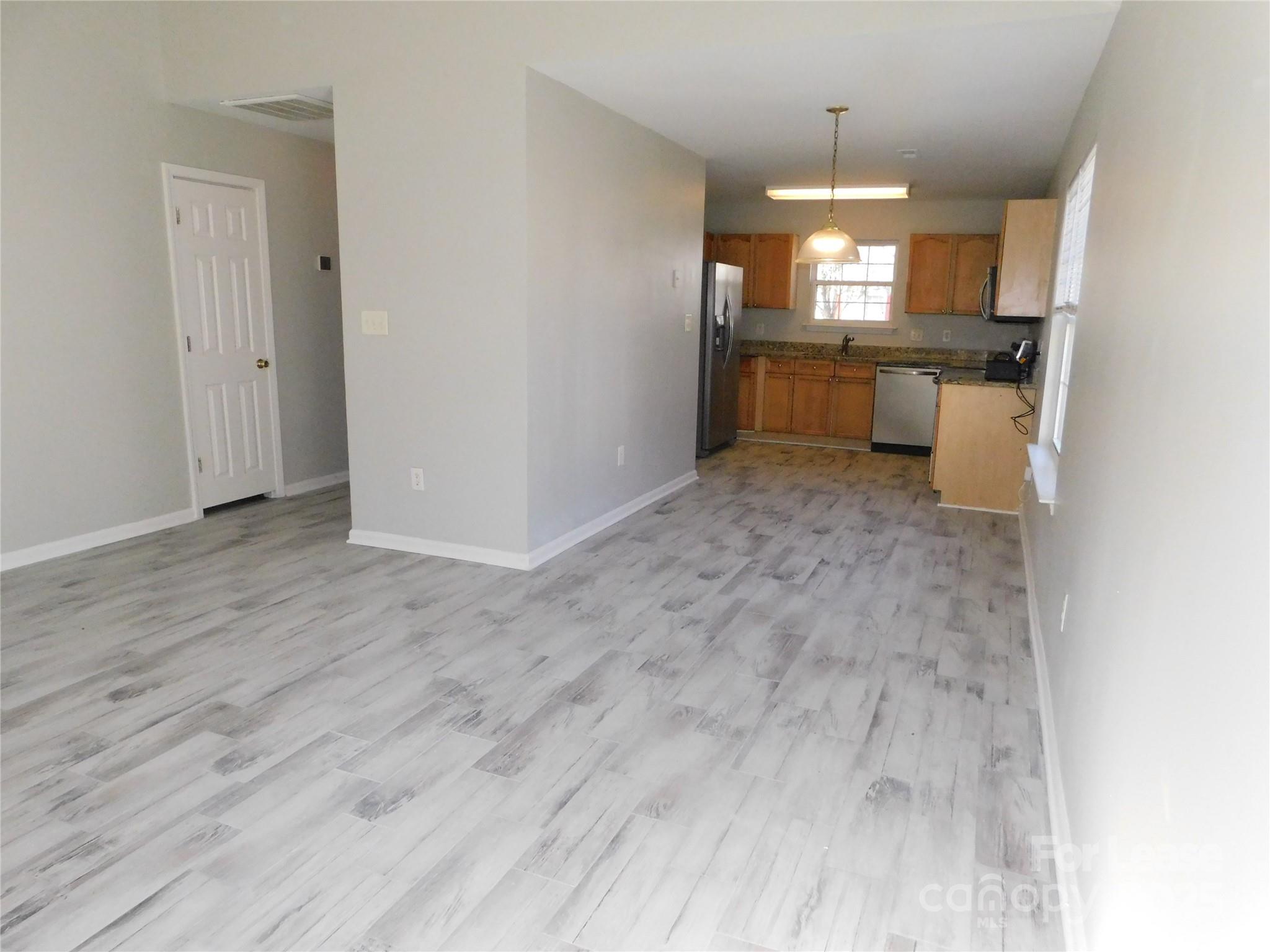 1119 Hannah Rae Court Charlotte, NC 28214 - Photo 9 of 19 a view of a kitchen with a sink wooden floor and a window