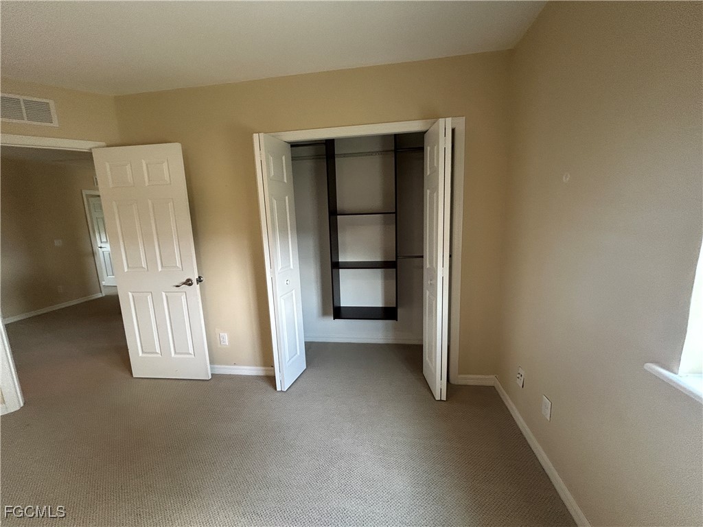 Undisclosed Address Cape Coral, FL 33991 - Photo 14 of 40 an empty room with windows and closet