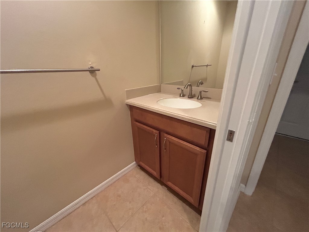 Undisclosed Address Cape Coral, FL 33991 - Photo 15 of 40 a bathroom with a sink and mirror