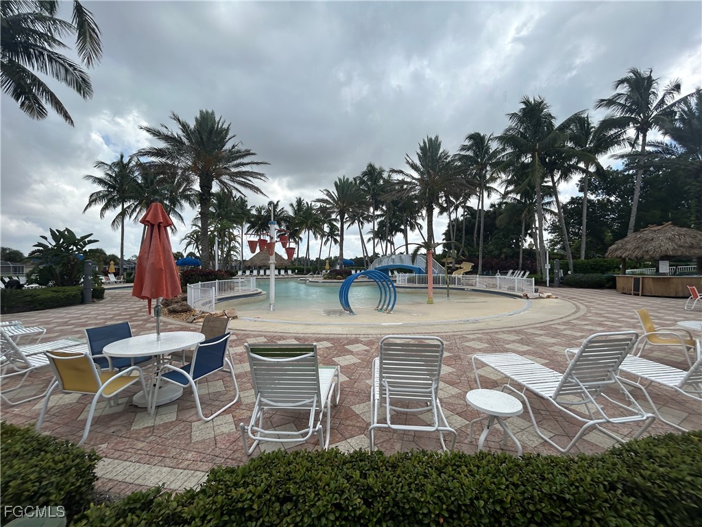 Undisclosed Address Cape Coral, FL 33991 - Photo 30 of 40 a view of a backyard with lawn chairs potted plants and palm trees