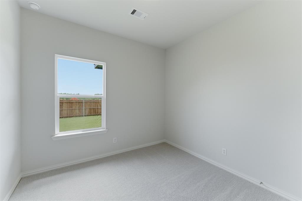 3504 Helena Street Gainesville, TX 76240 - Photo 11 of 19 Neutral-toned interior room featuring light gray carpeting and a single window with white trim