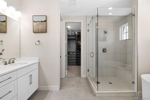a white bath tub sitting next to a shower