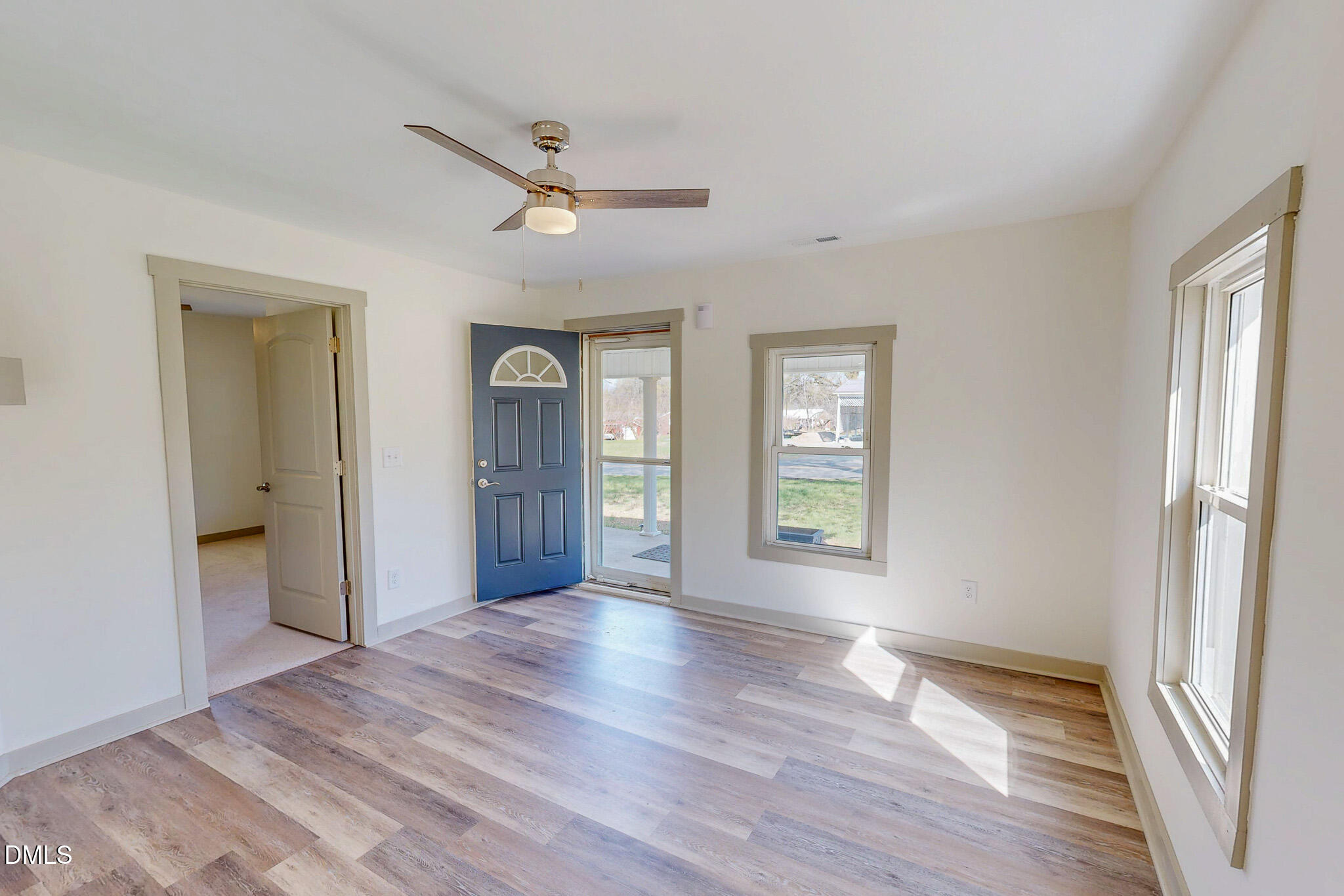 474 Providence Road Roxboro, NC 27573 - Photo 13 of 30 a view of an empty room with wooden floor and a window
