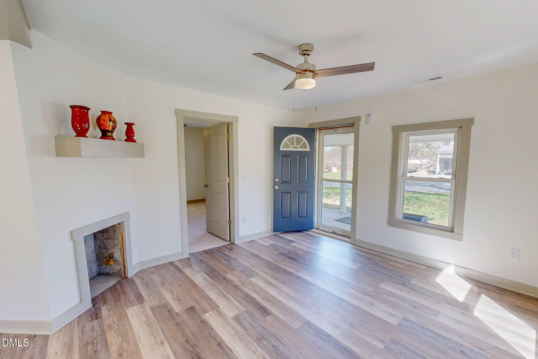 474 Providence Road Roxboro, NC 27573 - Photo 14 of 30 a view of an empty room with a window and wooden floor