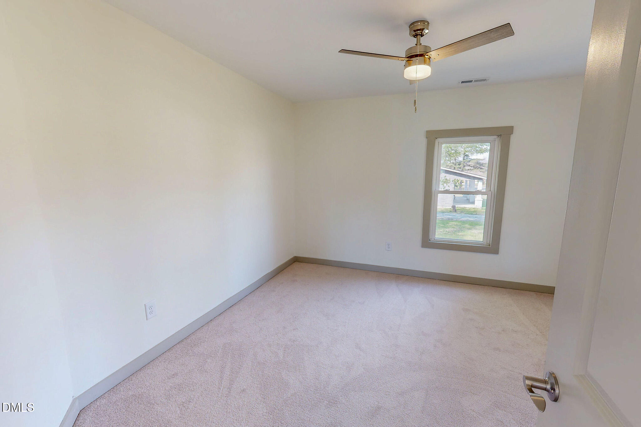 474 Providence Road Roxboro, NC 27573 - Photo 27 of 30 an empty room with a window and a fan
