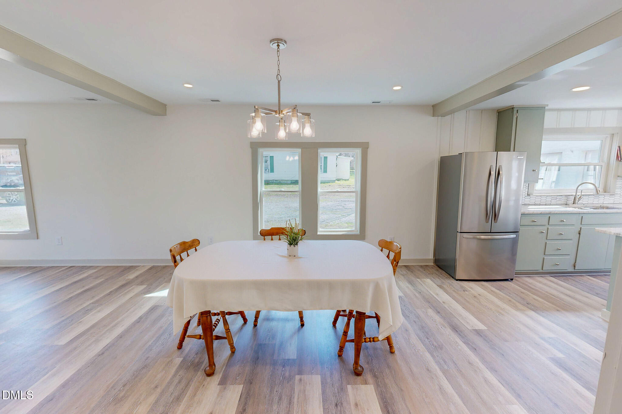474 Providence Road Roxboro, NC 27573 - Photo 28 of 30 a kitchen with stainless steel appliances a dining table chairs refrigerator and sink