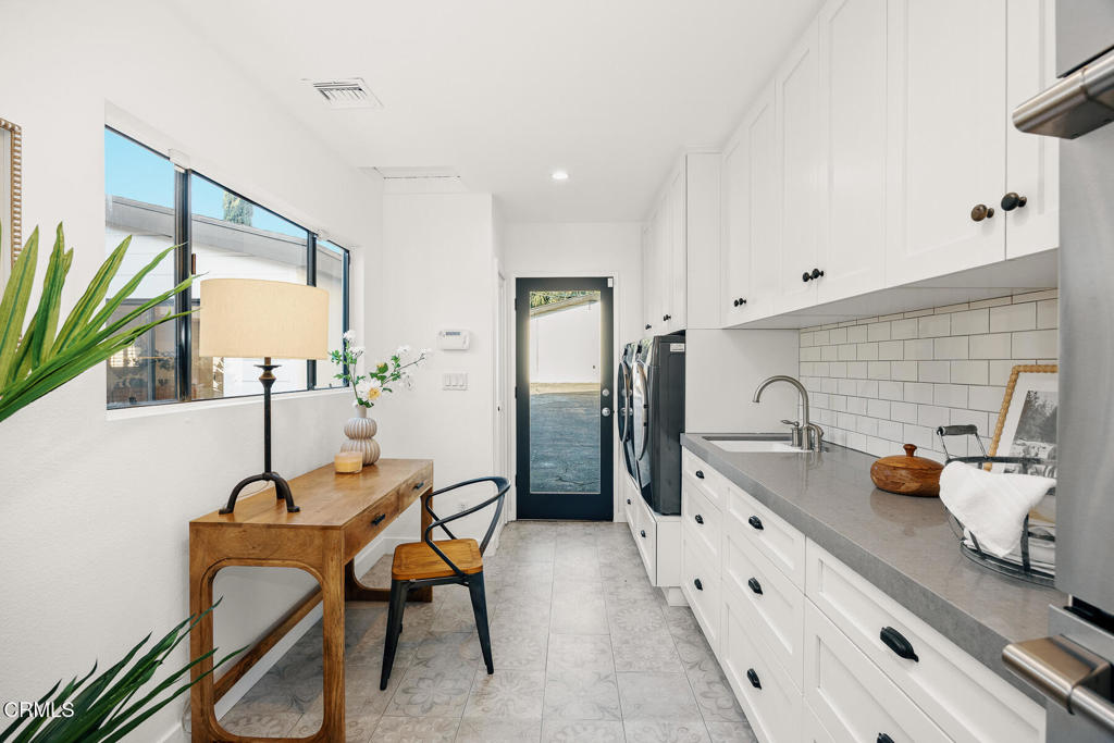 1245 East Howard Street Pasadena, CA 91104 - Photo 24 of 69 a kitchen with stainless steel appliances kitchen island granite countertop a sink and a refrigerator