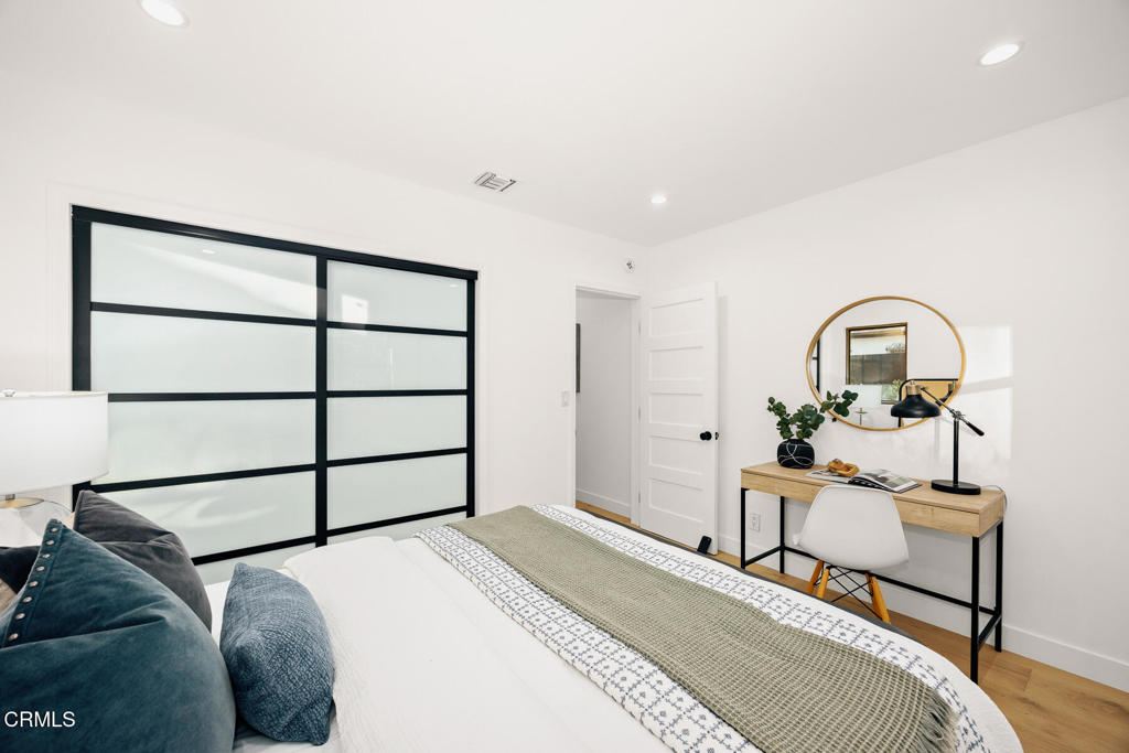 1245 East Howard Street Pasadena, CA 91104 - Photo 31 of 69 a bedroom with a bed and a dresser with mirror