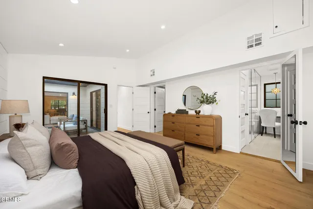 a living room with furniture and a kitchen area
