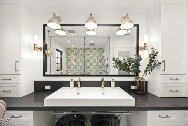 a kitchen with a sink a counter top space stainless steel appliances and cabinets