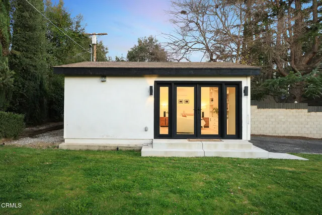 an aerial view of a house with a yard and pool