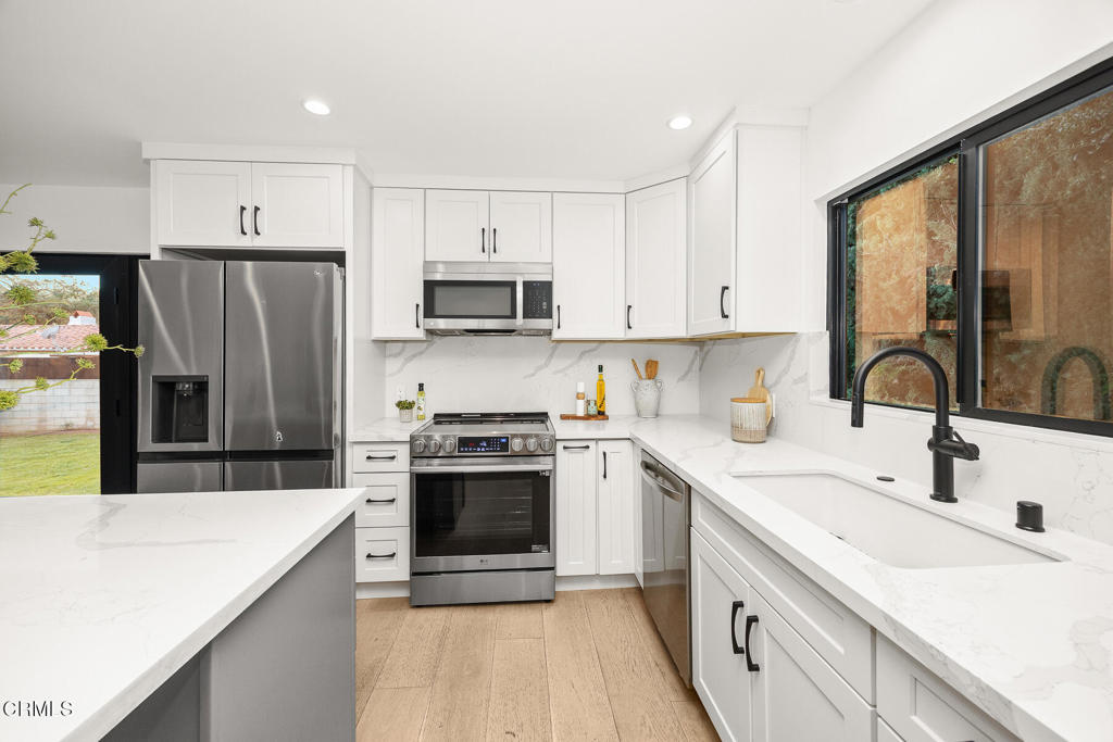 1245 East Howard Street Pasadena, CA 91104 - Photo 53 of 69 a kitchen with a sink a counter top space stainless steel appliances and cabinets