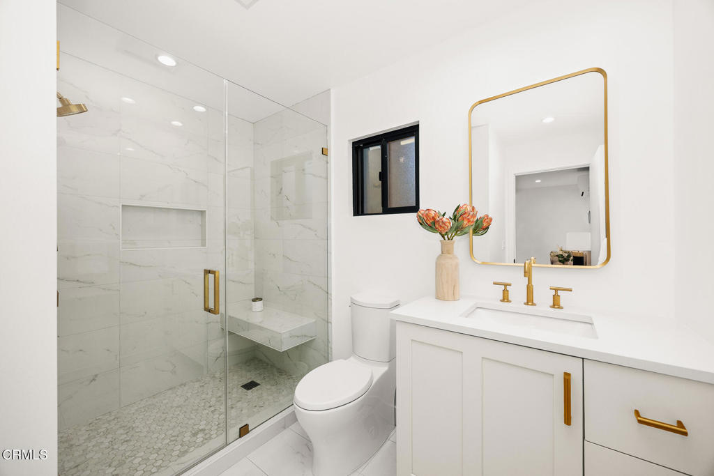 1245 East Howard Street Pasadena, CA 91104 - Photo 57 of 69 a bathroom with a sink a toilet a shower and a mirror