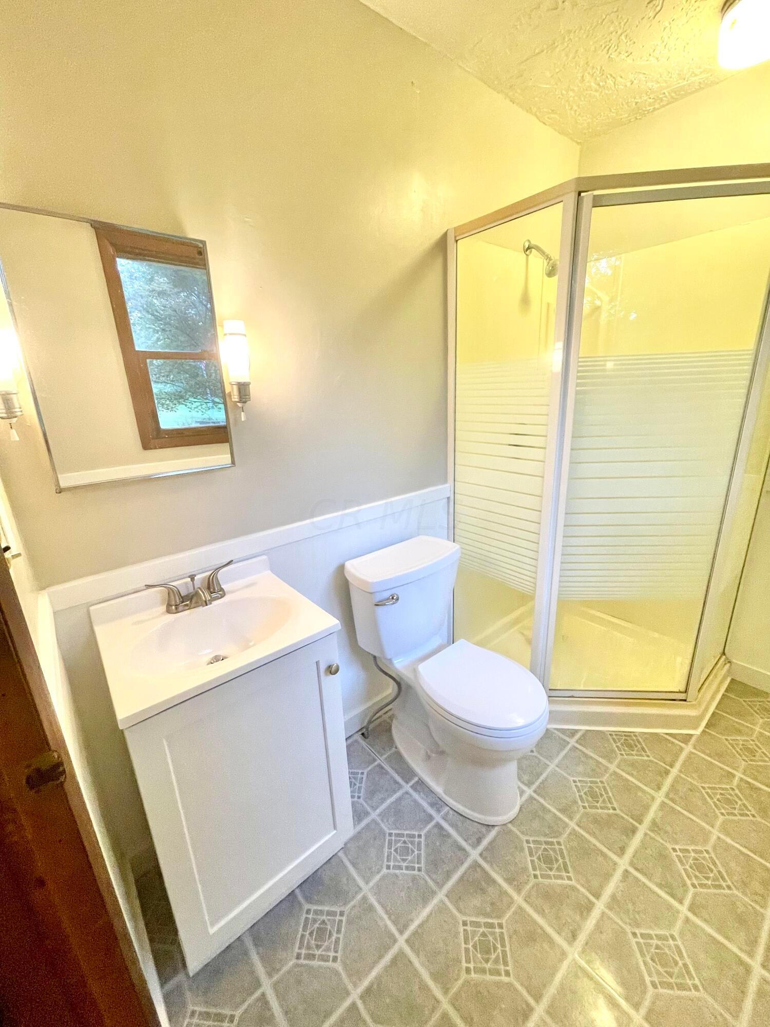 10671 Co Road East Liberty, OH 43319 - Photo 30 of 37 Updated master bathroom! New toilet, vanity, countertop, sink faucet, shower head, baseboard, paint and wainscoting.
