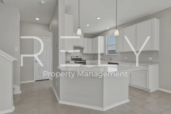 a kitchen with granite countertop a stove a sink and a cabinets