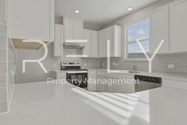 a kitchen with a sink cabinets and window
