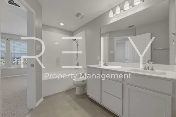 a bathroom with a granite countertop sink mirror and toilet