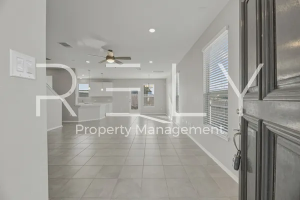 a view of a hallway with entryway and chandelier
