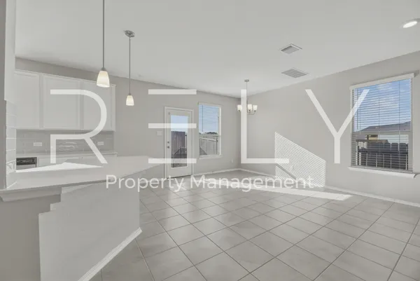 a view of a livingroom with kitchen and chandelier
