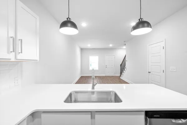 a view of a kitchen with a sink and a chandelier