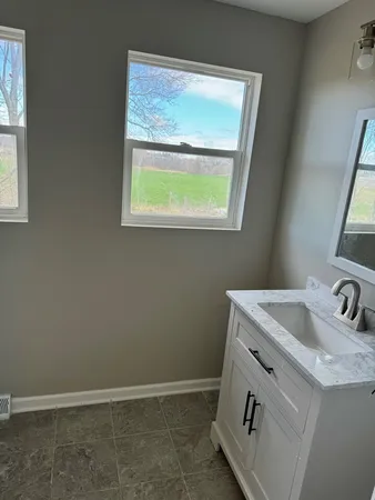 a bathroom with a sink and a window