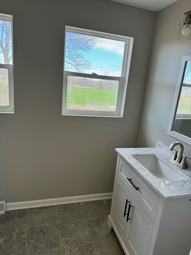 18708 Beck Road Marengo, IL 60152 - Photo 11 of 16 a bathroom with a sink and a window